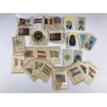 A quantity of early 20th Century cigarette silks and a series of "German Orders & Decorations"