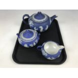 A Wedgwood dark blue Jasperware three-piece tea set