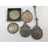 A Victorian 1891 silver crown, together with four Elizabeth II commemorative coins, three in white-