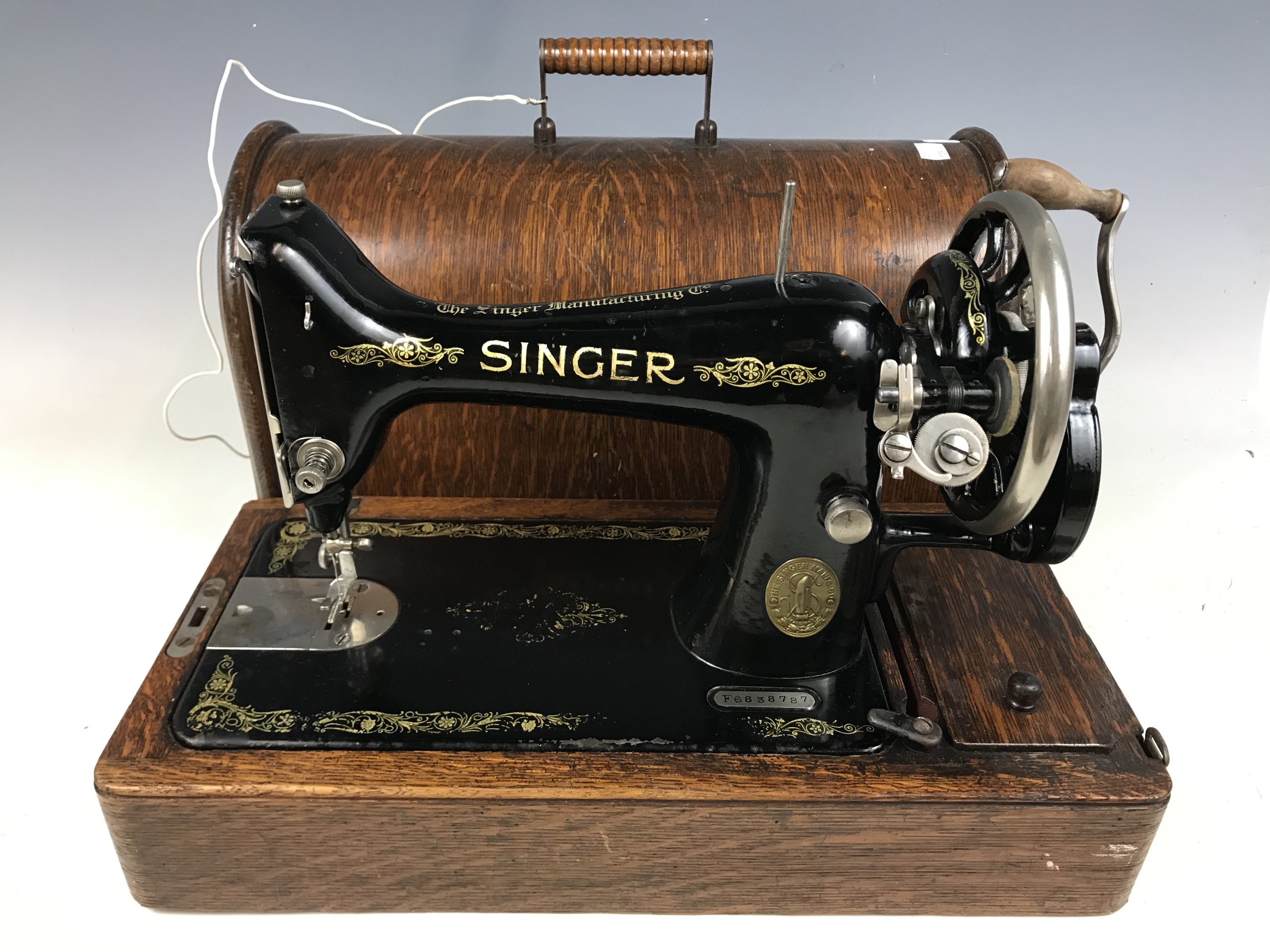 A cased Singer sewing machine with key