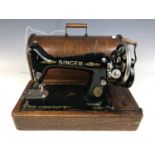A cased Singer sewing machine with key