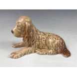 A Sylvac figurine of a recumbent spaniel, shape No.114