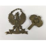 A cast brass clock key modelled as a Royal Marines badge, together with a Polish commemorative