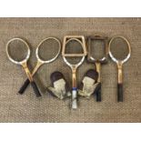 Vintage Dunlop wooden tennis rackets together with a pair of leather boxing gloves
