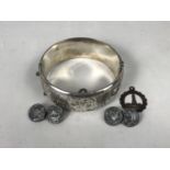 A silver hinged bangle, having foliate engraved decoration, together with a silver pendant and a