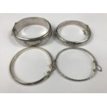 Four vintage silver / white-metal hinged bangles, three having assay marks, each with foliate