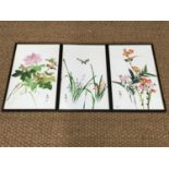 Three Japanese paintings on silk, depicting blossom and birds, framed under glass, 51 x 29 cm