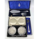 A cased pair of electroplate fish servers, together with cased butter dishes etc