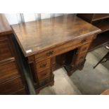 An old reproduction 18th Century mahogany kneehole desk of diminutive stature