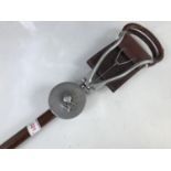 A vintage shooting stick with hardwood shaft and cast duralumin mounts