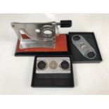 A guillotine type table cigar cutter and two Angelo brand cigar cutters, (boxed as-new)