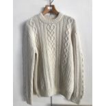 An Aran knitted white woollen jumper with epaulettes