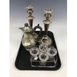 A pair of Victorian electroplate candlesticks, together with a jug and egg cup cruet