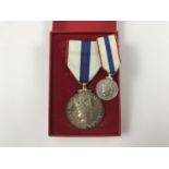 A cased QEII Silver Jubilee Medal and miniature