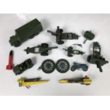 A small group of Dinky die-cast artillery pieces and military vehicles, together with related die-