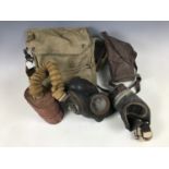 A Second World War British General Service Respirator and a civilian gas mask and haversack