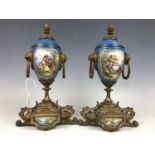 A pair of late 19th Century gilt and metal mounted Sevres style urns (one a/f)