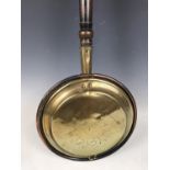 A 19th Century brass bed warming pan