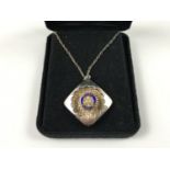 An Elizabeth II enamelled and parcel-gilt silver Rotary Club pendant necklace in original