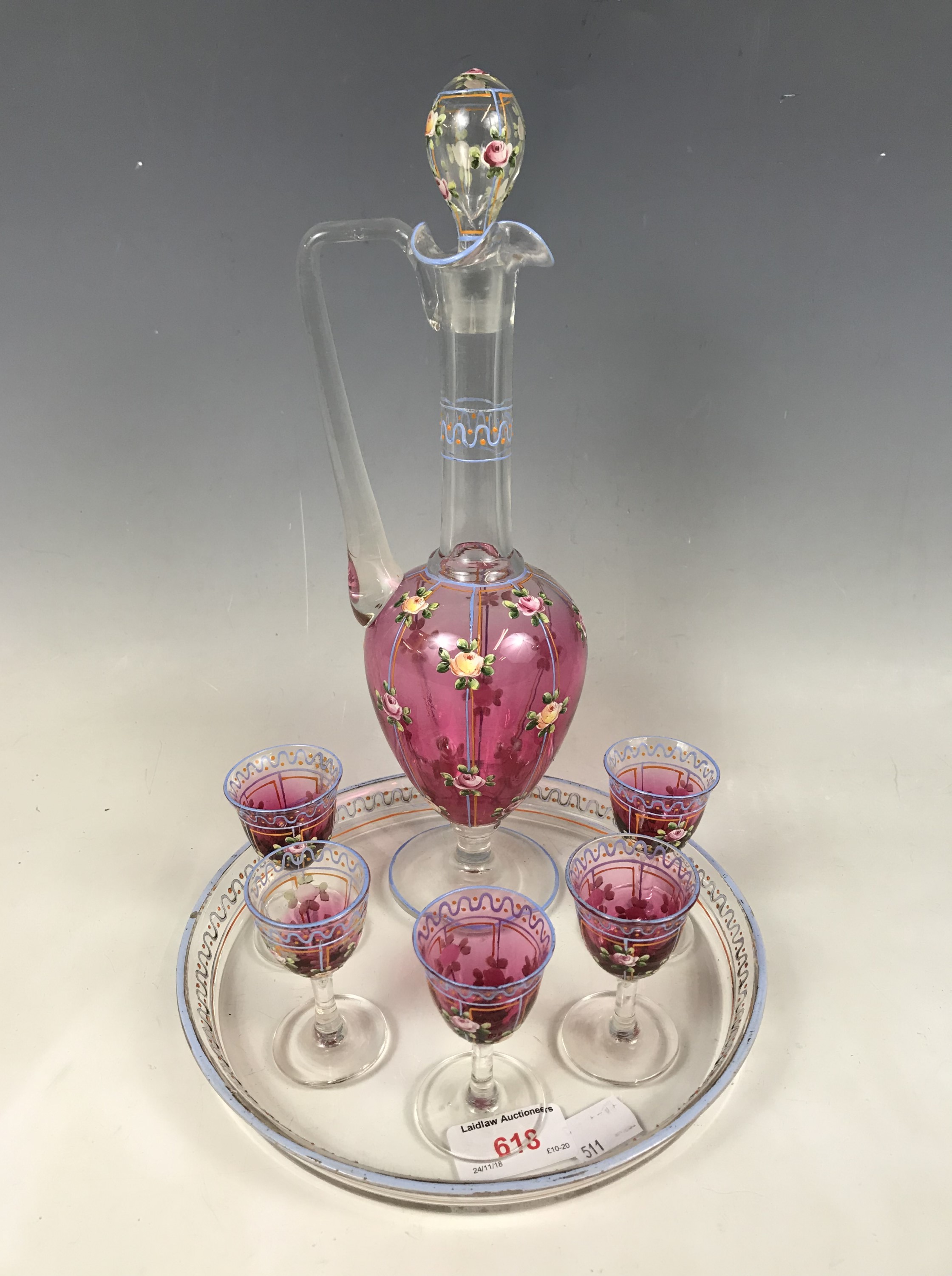 A floral enamelled glass liqueur / decanter set
