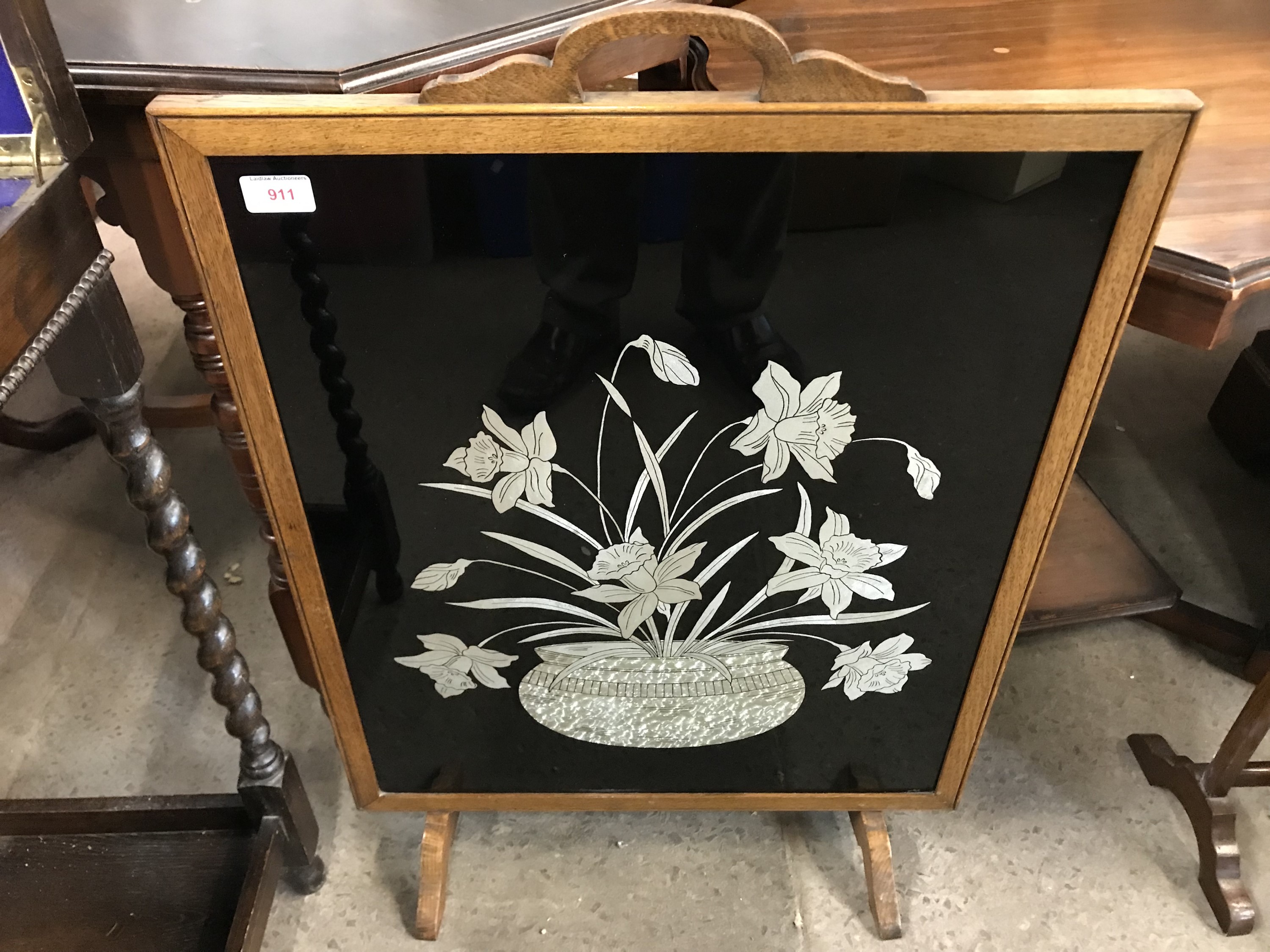 A 1920s mahogany fire screen with verre églomisé style glass insert