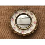 A vintage wall mirror, having a porcelain and gilt frame with transfer-printed chintz decoration, 48