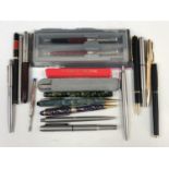 A collection of vintage and modern fountain and ballpoint pens, including a Conway Stewart 75