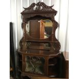 A late Victorian French-influenced glazed and mirror-backed mahogany display cabinet