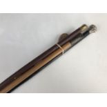 A Victorian slender ebonized walking cane with silver pommel, a swagger stick with silver pommel and