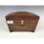 A Georgian mahogany sarcophagus form tea caddy, opening to reveal two covered compartments (later
