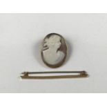 A modern yellow-metal mounted shell cameo brooch, carved with the profile of a Grecian goddess,