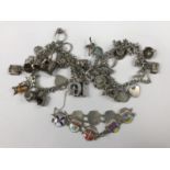 Two vintage white-metal charm bracelets with charms, 121g total, together with a German made white-