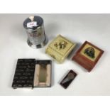 A Colibri lighter together with two mid 20th Century printed tinplate table cigarette boxes, a 1940s