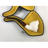 A meerschaum pipe, the bowl modelled as a bearded head, in associated case