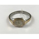 A lady's vintage 9ct gold cased Rotary wristwatch, having a cushion shaped case, silvered face,