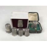 Silver and white-metal thimbles, including one 19th Century silver thimble in a fitted