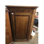 An early 19th Century mahogany cross-banded oak corner cabinet