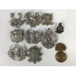 A quantity of British army cap badges etc, largely those of Scottish regiments