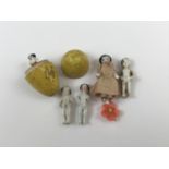Three Victorian porcelain 'pudding' dolls, together with one further miniature porcelain doll and