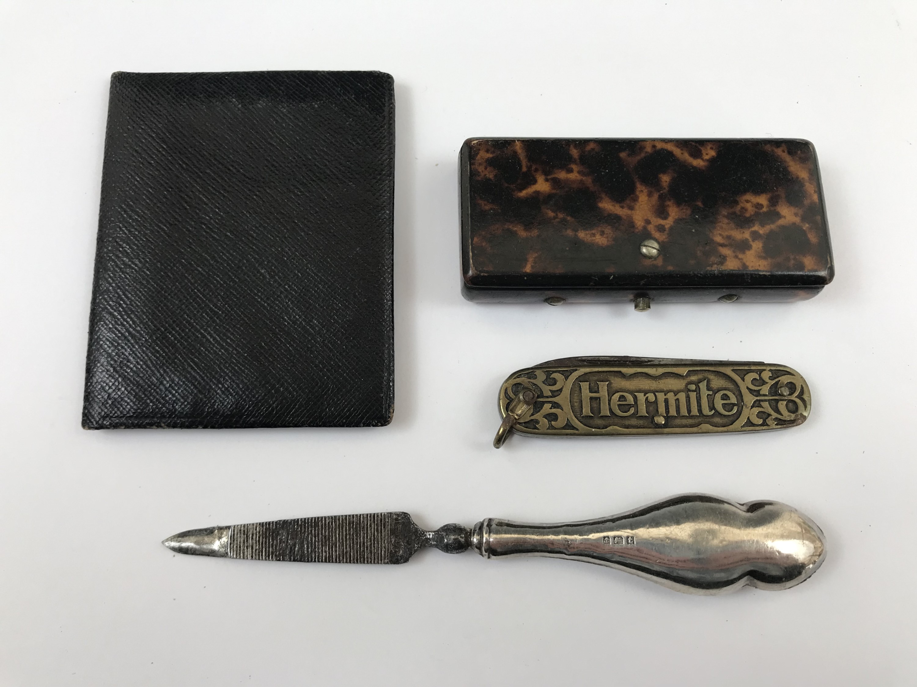 A 19th Century tortoiseshell vesta case together with a French pocket knife, a silver manicure