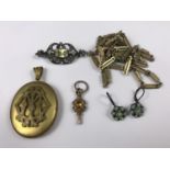 Period costume jewellery, including a Victorian gilt-metal locket with raised monogram, a white-