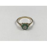 A 9ct gold, emerald and diamond ring, in a flower head cluster arrangement, 1.3g