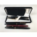 Vintage fountain pens including a Parker Slimfold, with 14K nib, a Waterman's Champion 501, with