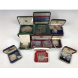 A quantity of cased British, Commonwealth and world silver, proof and other coins and