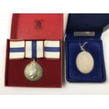 An Elizabeth II cased royal commemorative silver pendant necklace, together with one further boxed