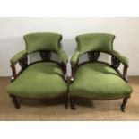 A pair of Victorian upholstered mahogany tub armchairs