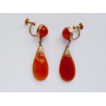 A vintage pair of yellow-metal and carnelian ear pendants, having a spherical cabochon stud above