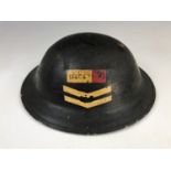 A Second World War Civil Defense Repair Party helmet