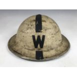 A Second World War Civil Defense Air Raid Warden's white-painted helmet