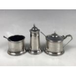 A George V silver cruet set, of Modernist influence, comprising pepperette, mustard and salt, each